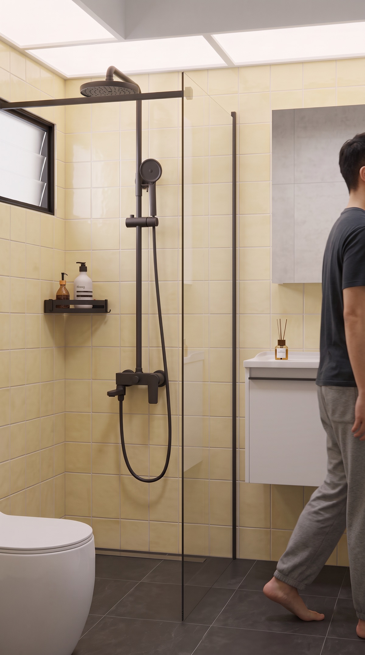 A man walking past a Matt Black round rain shower behind a clear glass panel